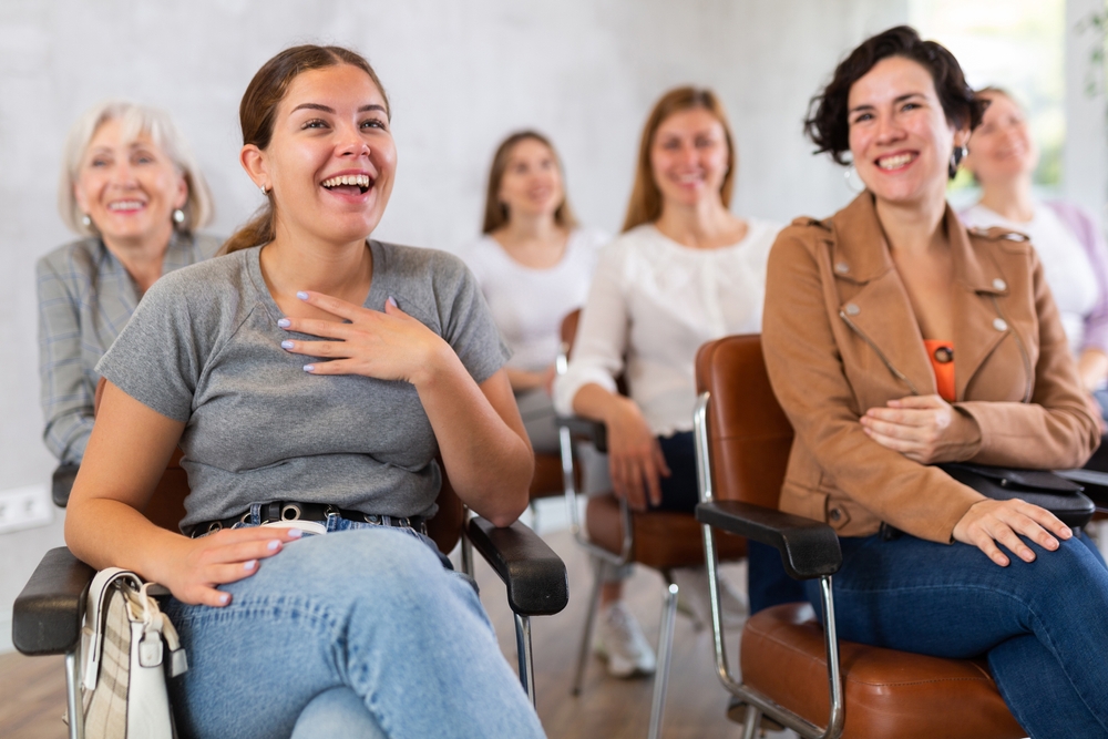 Small,Group,Of,Women,Are,Sitting,In,Audience,And,Listening